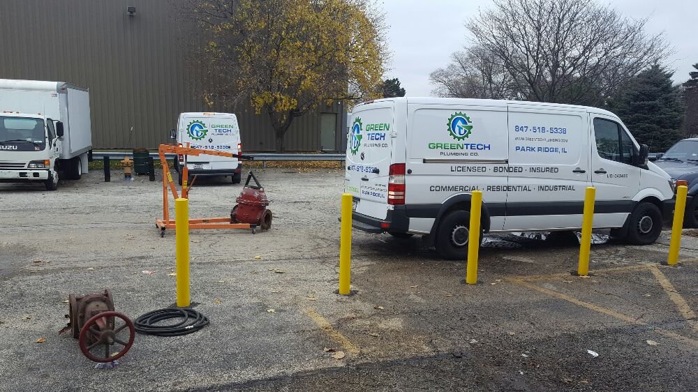 Plumbing work vans parked in parking lot
