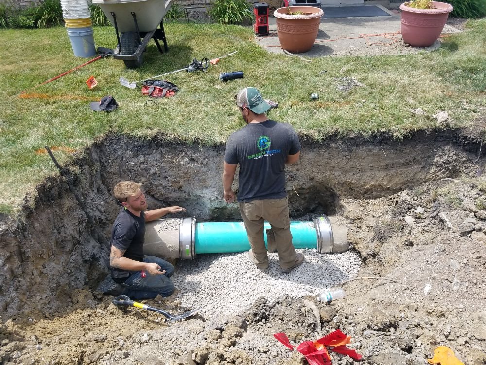 Plumbers working on a sewer pipe