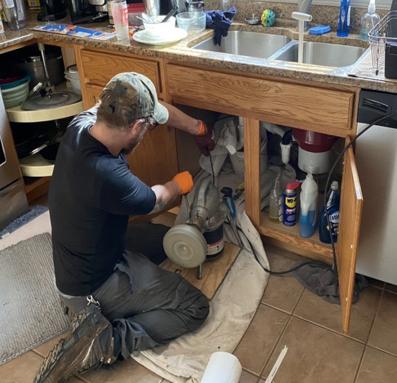 Plumber Rodding Kitchen Sink